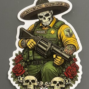 May include: A sticker illustration of a skeleton wearing a sombrero, a yellow shirt, and a green tactical vest with a badge reading HUESOS. The figure holds a large multi-shot grenade launcher, surrounded by red roses and two human skulls at the base.