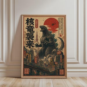 Könnte beinhalten: Ein gerahmtes Poster im Vintage-Stil mit Godzilla in einer Stadtkulisse mit japanischem Text. Das Kunstwerk verwendet eine Farbpalette aus Rot, Schwarz und Beige, mit einer großen roten Sonne im Hintergrund. Das Poster wird auf einem Holzboden präsentiert.