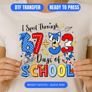 May include: A colorful DTF transfer featuring the text "I Sped Through 67 + 3 Days of School" with cartoon characters and school-themed graphics. The design includes the words "DTF TRANSFER" and "READY TO PRESS" in blue banners. The words "BRIGHT WHITES • QUICK SHIP" are also included.
