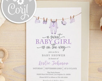 May include: A purple and white baby shower invitation with a watercolor illustration of baby clothes hanging on a clothesline. The text reads "a sweet baby girl is on the way".