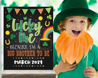 May include: A St. Patrick's Day themed digital download sign with the text "Lucky Me Because I'm a Big Brother to Be March 2024". The sign features a pot of gold, rainbow, shamrocks, and a leprechaun hat. A child is wearing a green hat and orange beard.