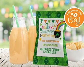 May include: A St. Patrick's Day themed party setup featuring two glass bottles of orange juice with green straws, a bag of chips, and a personalized snack bag with text: "Rainbows, Shamrocks & Pots of Gold".