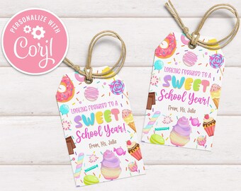 May include: Two rectangular paper gift tags with rounded top corners and brown twine loops. The white tags feature colorful illustrations of donuts, ice cream, candy, and sprinkles, with the text "LOOKING FORWARD TO A SWEET SCHOOL YEAR! From, Ms. Julie".