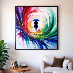 May include: Abstract painting in a black frame. A figure with a blue umbrella walks through a colorful vortex of red, purple, green, and blue brushstrokes. The artwork is displayed in a living room setting.