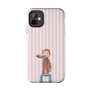 May include: A phone case featuring a cartoon monkey brushing its teeth, standing on a blue stool. The background has vertical pink and white stripes. The case is designed to fit a smartphone.