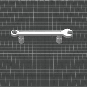 May include: A white spanner with a circular opening at one end and a U-shaped opening at the other. The spanner is supported by two cylindrical supports, set against a grid background.