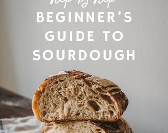 May include: Two halves of a sourdough loaf, showcasing a textured interior and crust. The bread rests on a striped linen cloth atop a dark wooden surface. Text reads "step by step BEGINNER'S GUIDE TO SOURDOUGH."