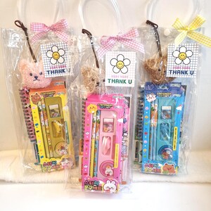May include: Three clear plastic gift bags with stationery sets. Each bag has a small teddy bear, a bow, and a tag that says "VERY VERY THANK U". The stationery sets are in yellow, pink, and blue.