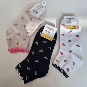 May include: A set of three ceramic mugs with a speckled, matte finish. The mugs are in shades of blue, green, and white. Each mug has a simple, modern design, perfect for coffee or tea.