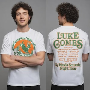 May include: White t-shirt featuring a circular graphic with a deer and the text "My Kinda Saturday Night Tour" and "Luke Combs". The back of the shirt displays "Luke Combs" in green and orange, along with tour locations.