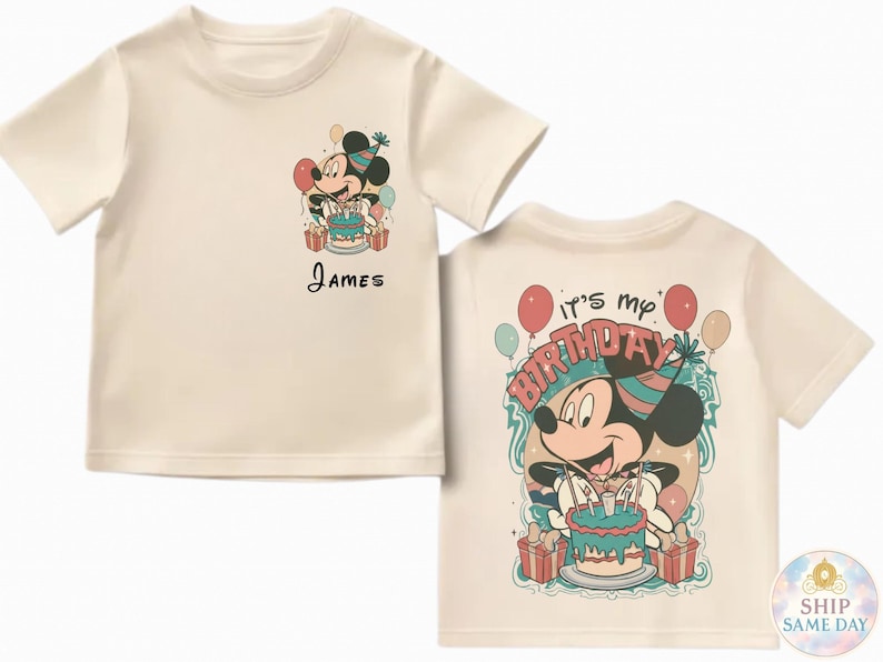 May include: Cream-colored t-shirt featuring a Mickey Mouse graphic with a birthday cake and the name "James". The back of the shirt says "It's my birthday" with Mickey holding a cake. Balloons and presents are also shown.