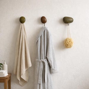 May include: A white ceramic mug with a black handle and the text "But First, Coffee" in a bold, black font. The mug is set against a blurred background, suggesting a cosy setting.