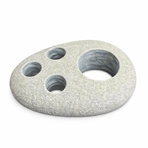 May include: A gray stone toothbrush holder with four circular openings. The holder has a smooth, rounded shape and a speckled texture. The openings are of varying sizes, designed to hold toothbrushes and other bathroom accessories.
