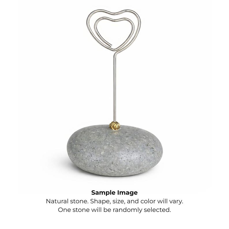 May include: A gray, natural stone base with a silver-colored wire heart-shaped top. The wire is attached to the stone with a small gold-colored accent. The text "Sample Image" and other text are at the bottom.