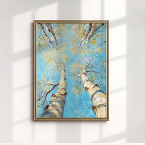May include: An oil painting framed in gold depicts a view looking up through the canopy of tall birch trees. The trunks are white with black markings, and the leaves are yellow against a bright blue sky. The artwork is a vertical rectangle.