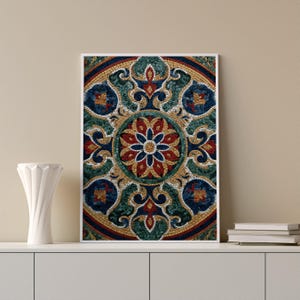 May include: Framed mosaic art print with a detailed floral design in a circular pattern. The artwork uses a vibrant palette of red, blue, green, and gold, creating a rich and intricate composition. The print is displayed on a white shelf.