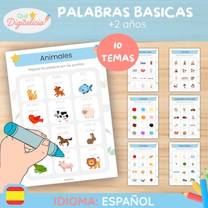 May include: A set of educational printables in Spanish for children aged 2+, featuring vocabulary words. The main sheet focuses on animals, with illustrations and the word in Spanish. Other sheets cover topics like colors, food, and family. A hand is holding a blue marker.