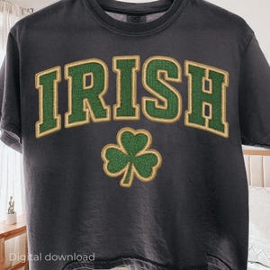 May include: Dark gray t-shirt with the word "IRISH" in green block letters with gold trim and a green shamrock. The shirt is a crew neck and has short sleeves. The words "Digital download" are at the bottom.