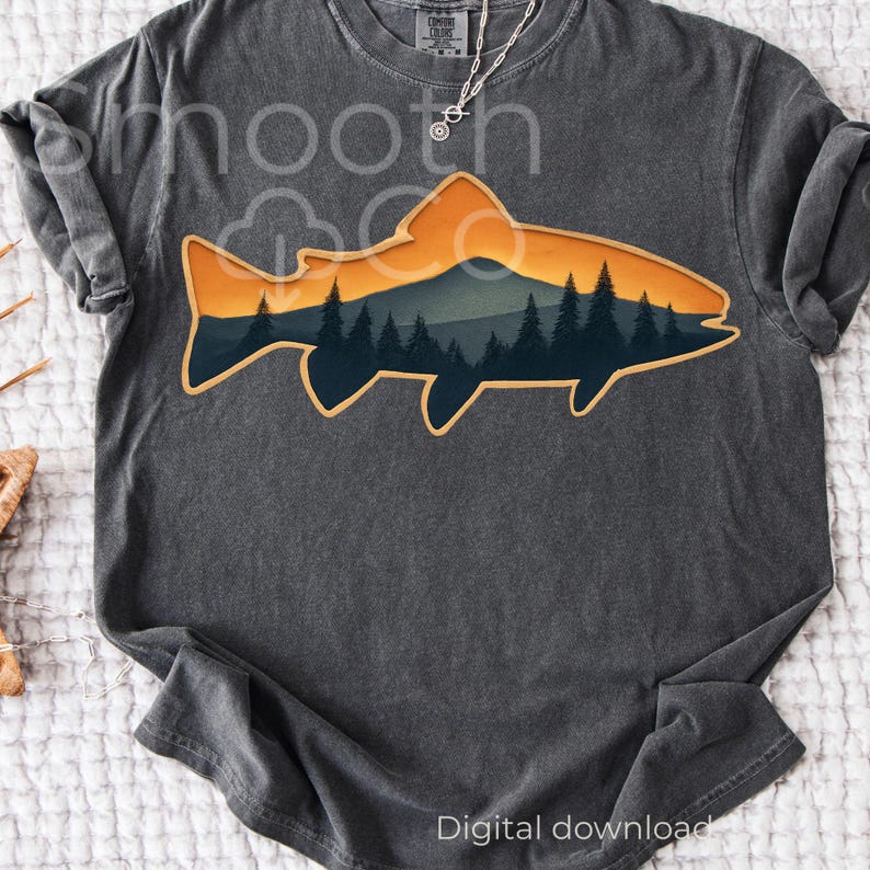 May include: Dark gray t-shirt featuring a fish-shaped design with a mountain and forest scene in shades of orange, blue, and green. The shirt has the words "smooth" and "Digital download" printed on it.