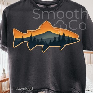 May include: Dark gray t-shirt featuring a fish-shaped graphic with a mountain and forest scene in shades of orange, blue, and green. The text "Smooth Co" is printed above the graphic. The words "Digital download" are printed at the bottom.