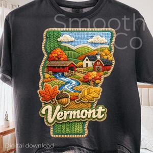 May include: Dark gray t-shirt featuring a detailed embroidered design of the state of Vermont. The design includes a river, covered bridge, houses, and autumn foliage. The word "Vermont" is prominently displayed in a cream-colored font. The words "Digital download" are at the bottom.