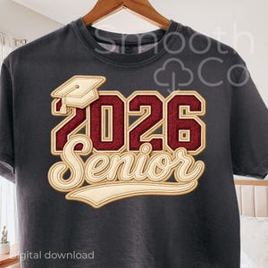 May include: Dark gray t-shirt featuring a graduation cap and the text "2026 Senior" in a maroon and cream color scheme. The design has a vintage, distressed look, perfect for a graduation gift.