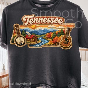 May include: Dark gray t-shirt featuring a colorful embroidered design with the word "Tennessee" in a banner. The design includes a banjo, guitar, cabin, river, mountains, and trees. The words "Digital download" are at the bottom.