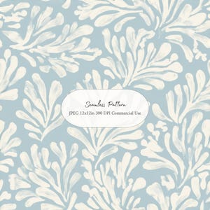 May include: A seamless pattern featuring off-white, brushstroke-style coral or seaweed shapes on a dusty blue background. A central white oval label contains the text: Seamless Pattern, JPEG 12x12in 300 DPI Commercial Use.