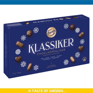 May include: A blue box of Fazer Klassiker assorted chocolates. The box features the brand name and product name in white, along with snowflake and chocolate illustrations. The box contains 280g of chocolates.
