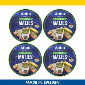 May include: Four round cans of Abba Klassisk Matjes herring, each with a blue and green label. The cans feature an image of the herring with dill and bread. The text "MADE IN SWEDEN" is at the bottom.