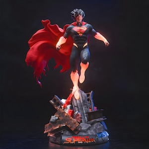 May include: A Superman figurine in a dynamic pose, with a red cape billowing behind him. The figure is clad in a black and blue suit with a red 'S' emblem. The base features debris and the word 'Superman'.