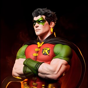 May include: A detailed statue of Robin, a DC Comics superhero, with a red and green costume, black cape, and green mask. The figure has crossed arms and a determined expression, with the iconic "R" emblem on the chest.