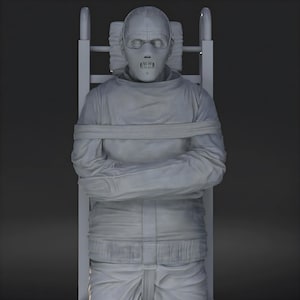 May include: A gray sculpture of a person restrained in a straight jacket and mask, seated in a chair-like structure. The figure's arms are crossed, and the head is tilted back. The overall aesthetic is somber and unsettling.