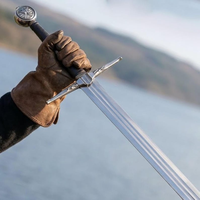 May include: A set of three ceramic mugs with a speckled, matte finish in cream, light grey, and dark grey. Each mug has a simple, minimalist design and a rounded handle.