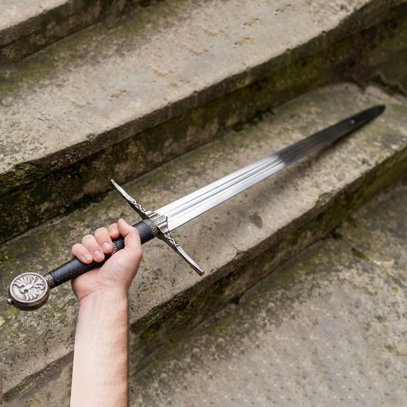 May include: A trio of cream-glazed ceramic mugs, each adorned with a hand-painted floral pattern in blue, green, and yellow. The mugs have a speckled finish and a classic, rounded design with a handle. Ideal for tea or coffee.