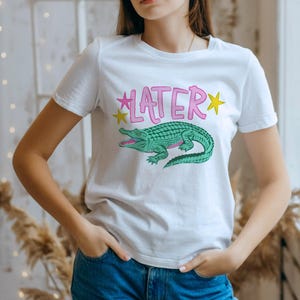 Hand-drawn teal and pink alligator with bold blue graffiti "LATER" text and green stars, boy aesthetic preppy streetwear style for sublimation and DTF.