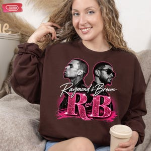 A promotional graphic featuring singers Chris Brown and Usher back-to-back, with the text "Raymond & Brown R and B" in sparkly pink and white lettering against a dark geometric background.