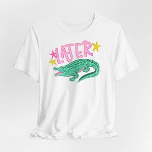 Hand-drawn teal and pink alligator with bold blue graffiti "LATER" text and green stars, boy aesthetic preppy streetwear style for sublimation and DTF.