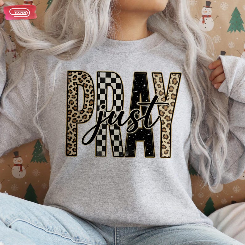 Bold "PRAY" text with leopard, checkerboard, and starry patterns, overlaid with a cursive "just" script, featuring a gold outline.