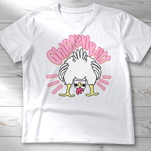 Lifestyle mockup of a preppy girl wearing a white oversized t-shirt featuring the funny pink Guess What Chicken Butt matching front and back sublimation designs.