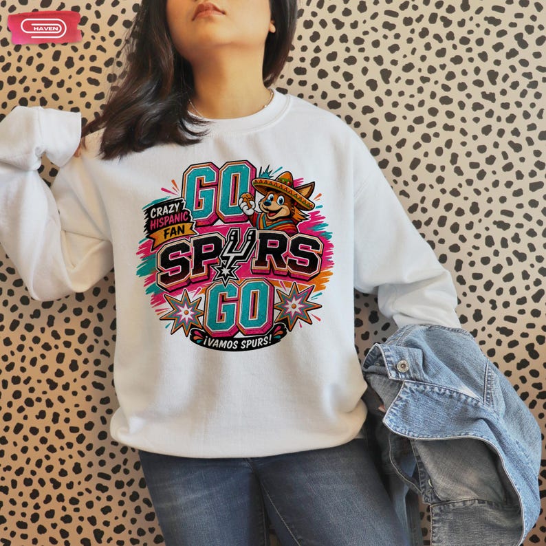 Colorful retro-style San Antonio Spurs basketball graphic featuring a coyote mascot wearing a sombrero, with bold 3D text reading Crazy Hispanic Fan, Go Spurs Go, and ¡Vamos Spurs! in neon pink, teal, and orange on a black background.