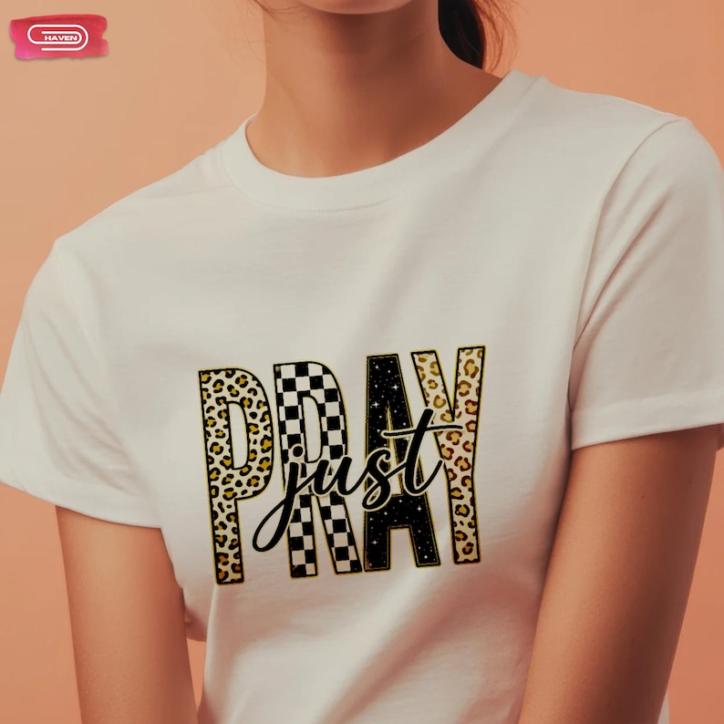 Bold "PRAY" text with leopard, checkerboard, and starry patterns, overlaid with a cursive "just" script, featuring a gold outline.