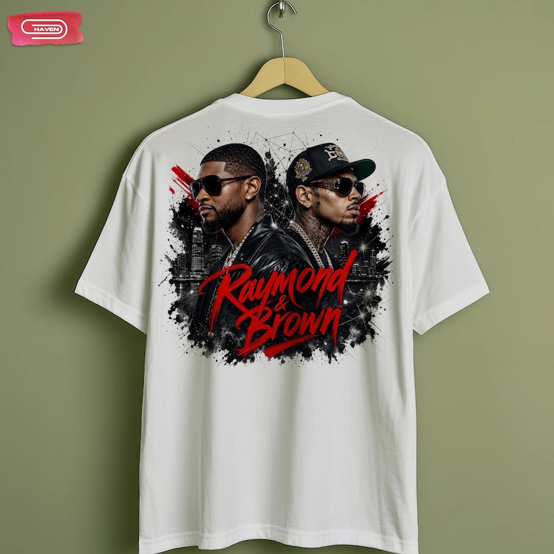 Digital bootleg rap tee graphic featuring R&B artists Usher and Chris Brown standing back-to-back wearing sunglasses and black jackets. The background showcases a high-contrast nighttime city skyline with glowing lights, abstract geometric stars, and bold red brushstroke text reading "Raymond & Brown".