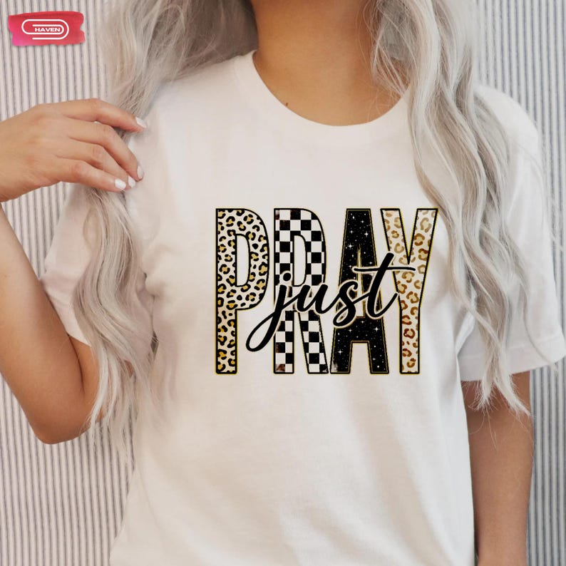 Bold "PRAY" text with leopard, checkerboard, and starry patterns, overlaid with a cursive "just" script, featuring a gold outline.