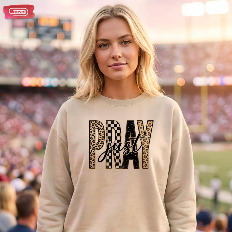 Bold "PRAY" text with leopard, checkerboard, and starry patterns, overlaid with a cursive "just" script, featuring a gold outline.