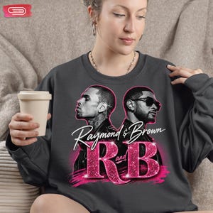 A promotional graphic featuring singers Chris Brown and Usher back-to-back, with the text "Raymond & Brown R and B" in sparkly pink and white lettering against a dark geometric background.