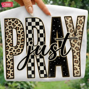 Bold "PRAY" text with leopard, checkerboard, and starry patterns, overlaid with a cursive "just" script, featuring a gold outline.