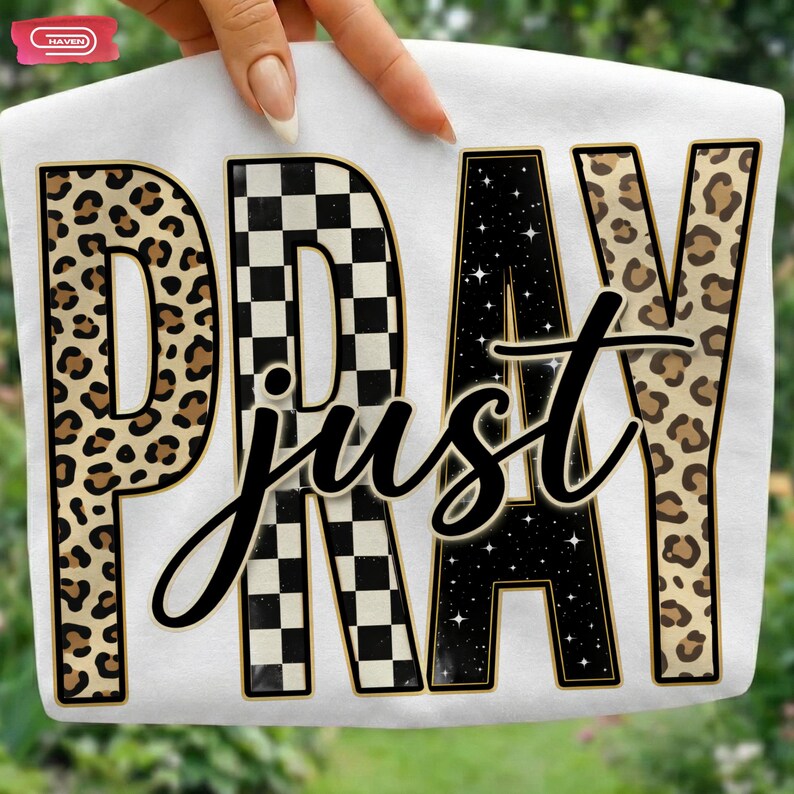 Bold "PRAY" text with leopard, checkerboard, and starry patterns, overlaid with a cursive "just" script, featuring a gold outline.