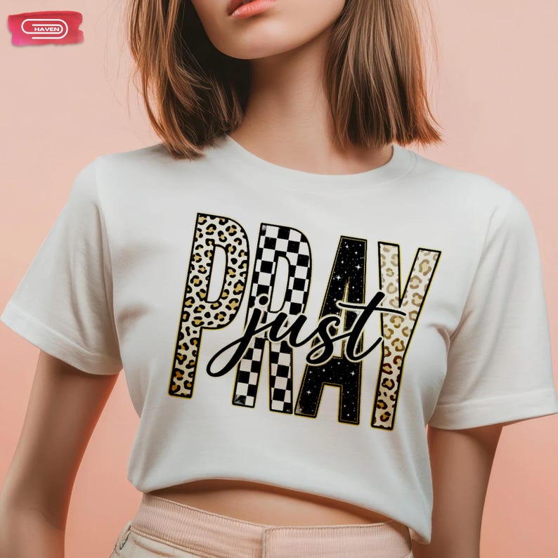 Bold "PRAY" text with leopard, checkerboard, and starry patterns, overlaid with a cursive "just" script, featuring a gold outline.
