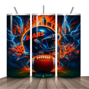 May include: A set of three stainless steel tumblers with a vibrant design featuring a football helmet, football, and cityscape. The design includes the word "BEARS" and lightning bolts in orange and blue.